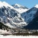 The town lies at the base of rugged, snow-covered peaks.