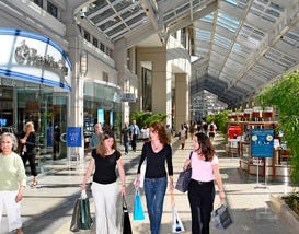 Customers with bags in hand walk the aisles of The Shops at Prudential Center in Boston, Massachusetts.