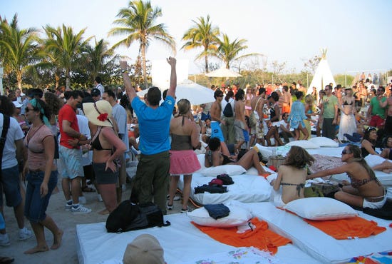 Patrons enjoy a festive atmosphere at  Nikki Beach, Miami.
