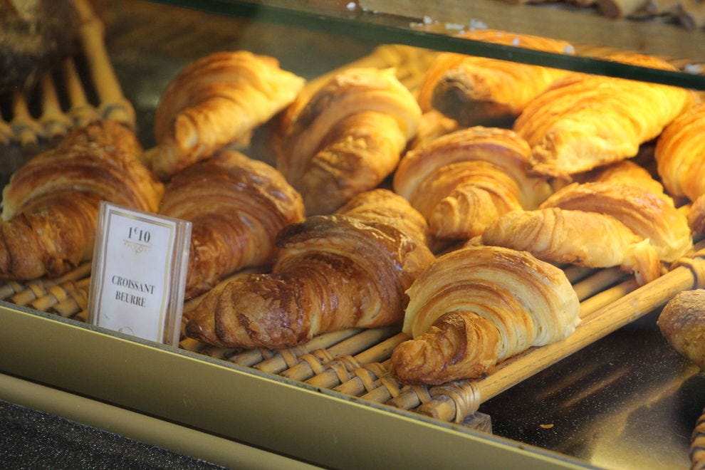 Butter croissants in a bakery case