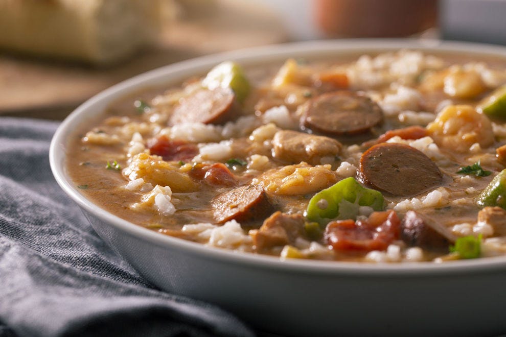 Creole gumbo is typically a tomato-based stew, while Cajun gumbo is made with a dark roux