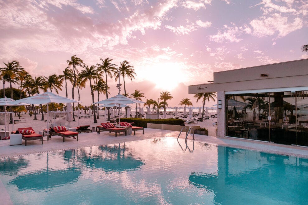 In Aruba, the pool at Bucuti &amp; Tara Beach Resort is open around the clock to toast the cotton candy sky as the sun sets over Eagle Beach