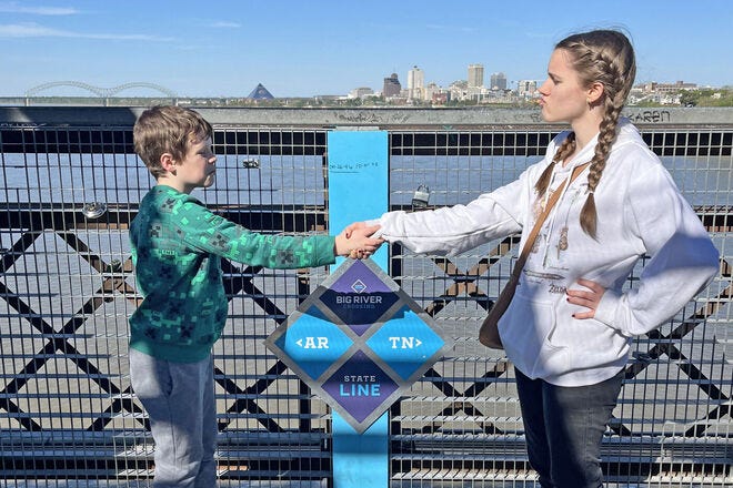 Shaking hands on the longest public pedestrian bridge over the Mississippi River