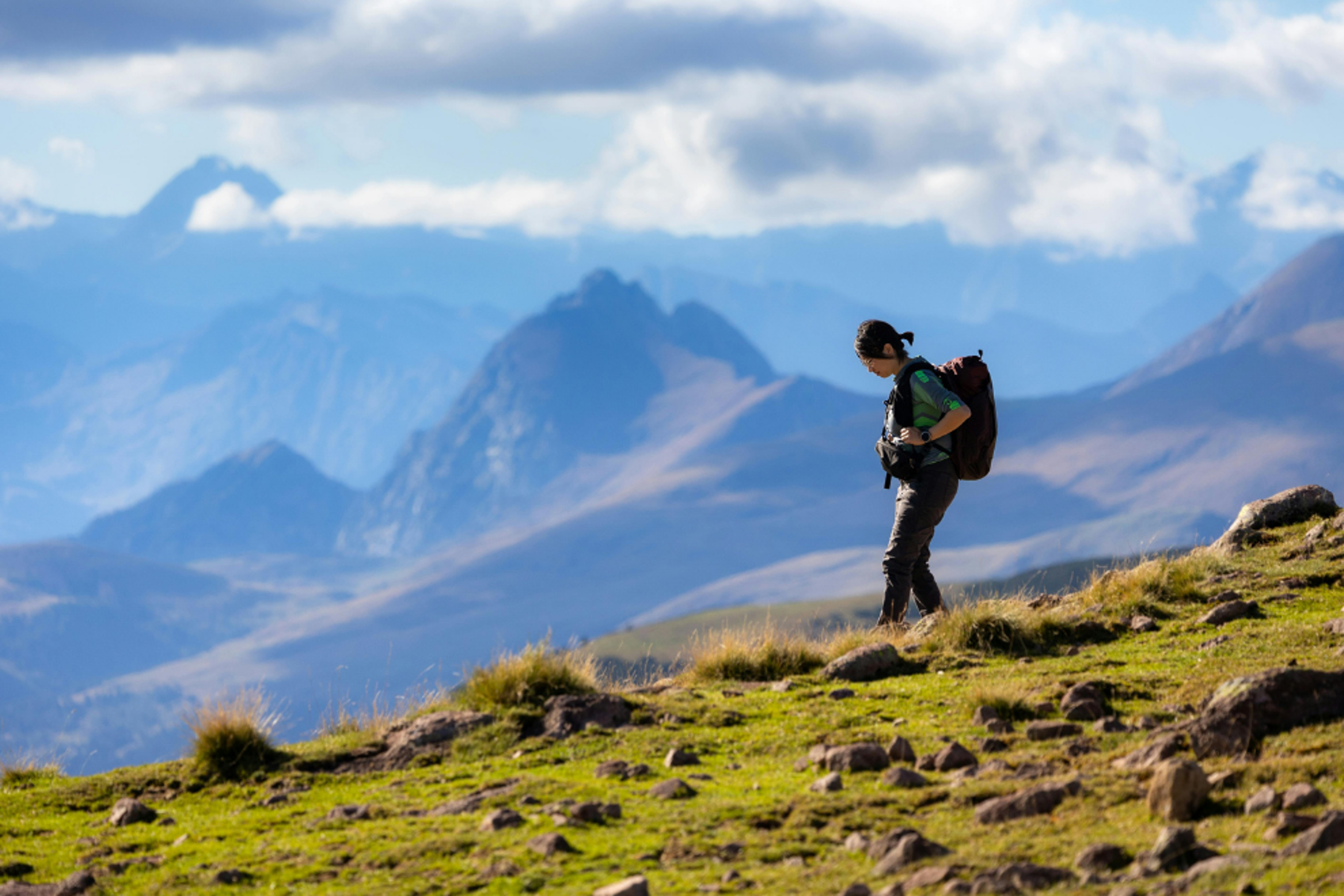 Woman hiking in scenic Alpine mountains.